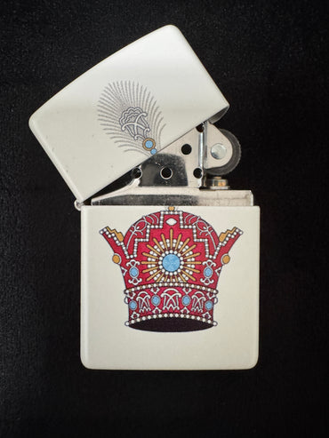 White lighter with red jeweled Pahlavi Crown design on black backgroundD
