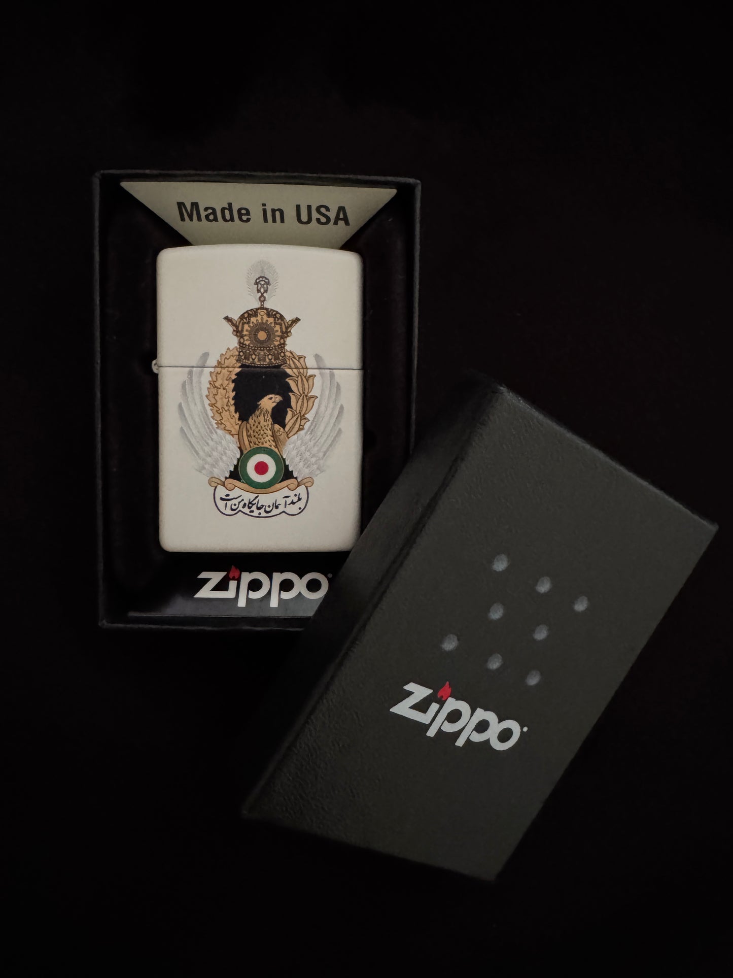 Image Alt Text English

White lighter with Imperial Iranian Air Force emblem, golden eagle, silver wings, royal crown, and “The High Sky Is My Place”