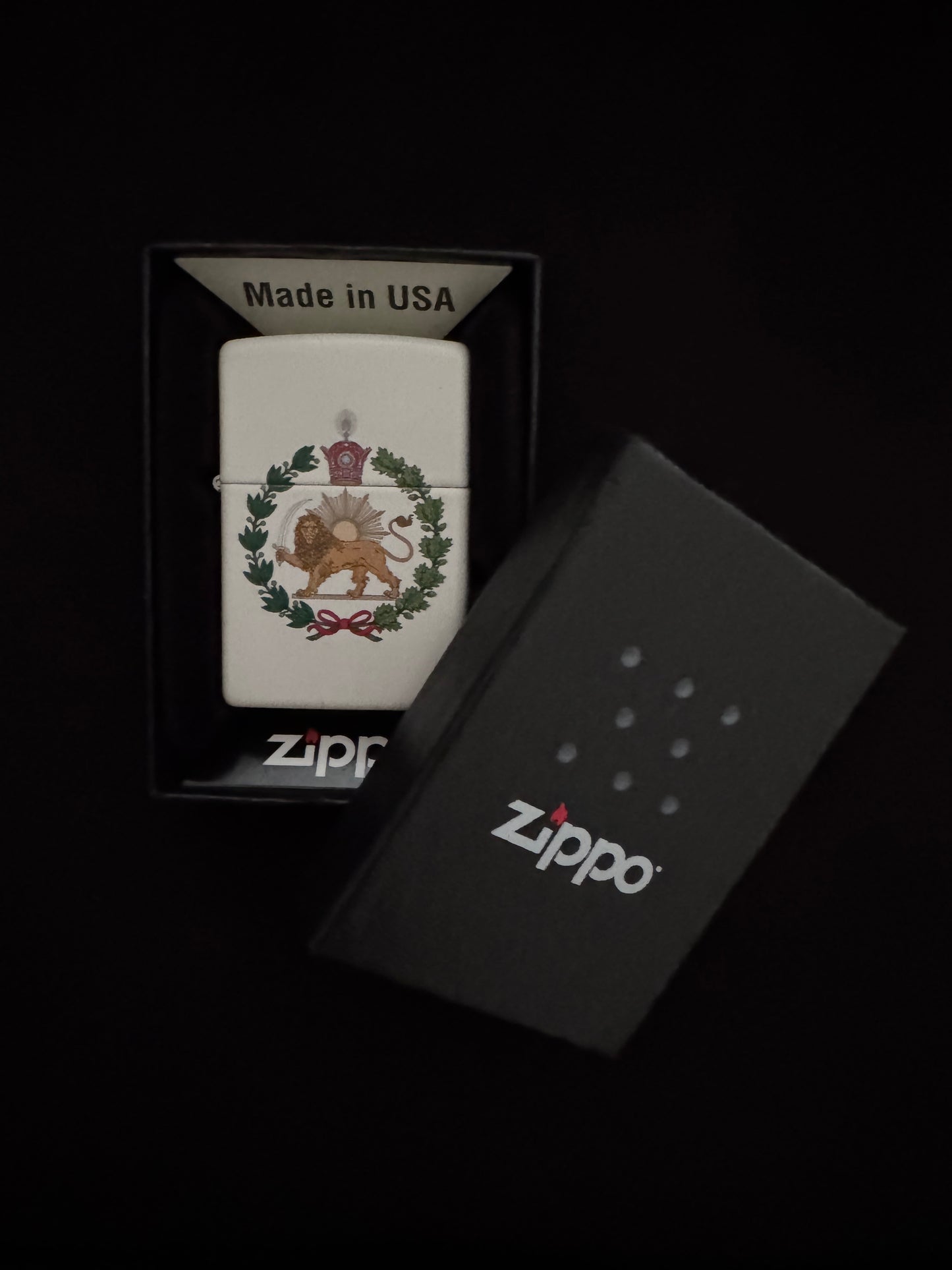 White lighter with a Crowned Lion and Sun emblem, Pahlavi Crown, and green wreath